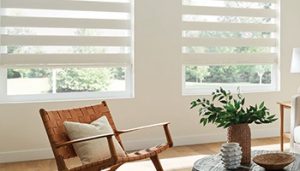 Layered white shades on two living room windows..