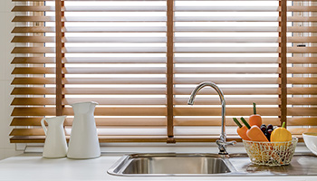 Faux wood blinds in kitchen.